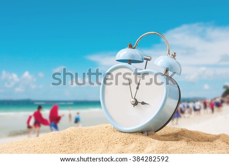 old retro clock on sand beach ,vintage color tone,abstract background to  time for summer vacation concept.