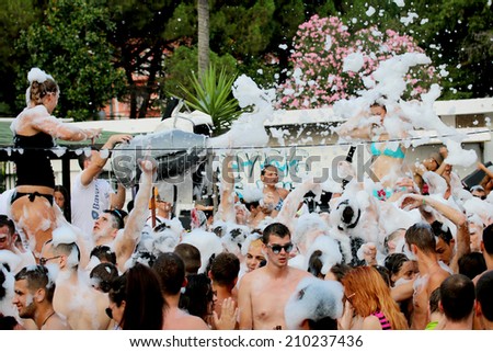 Foam Party on the beach in Igalo, Montenegro, july 26, 2014. Group of people enjoying in drinking, dancing and  music.