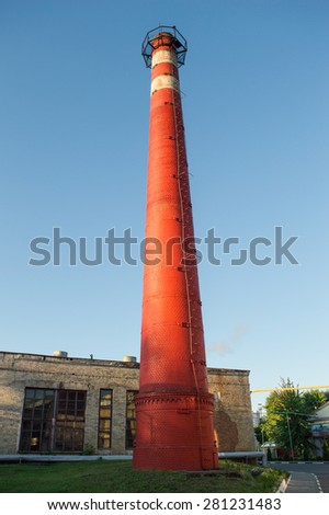 Red briks masonry factory pipe on blue sky background