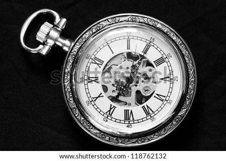 Old watch machine on black background