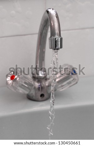 Water tap with flowing water