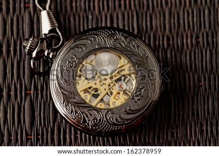 Old watch machine on dark background