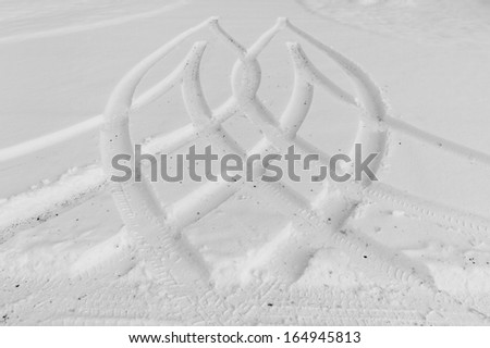 Traces from wheels of the car on snow