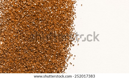 Brown glitter on light background - macro photo