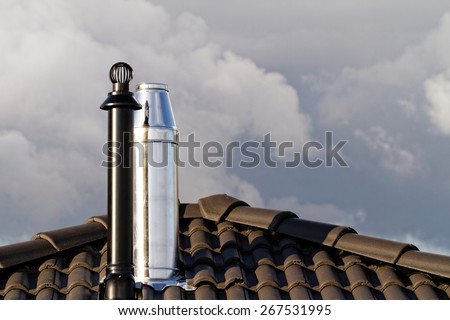 Modern chimney on the roof of house