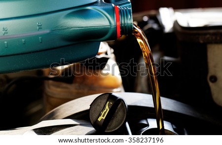 Fresh oil being poured during an oil change to a car