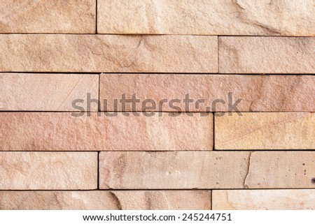 old wall stone tiles background with earth tone