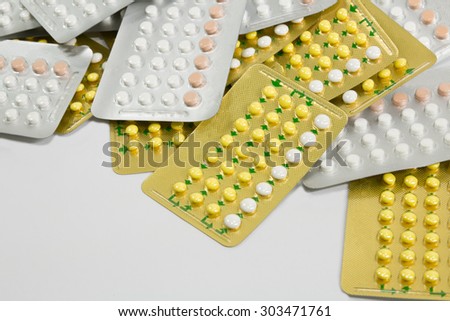 Birth control pills in plastic stall on white background