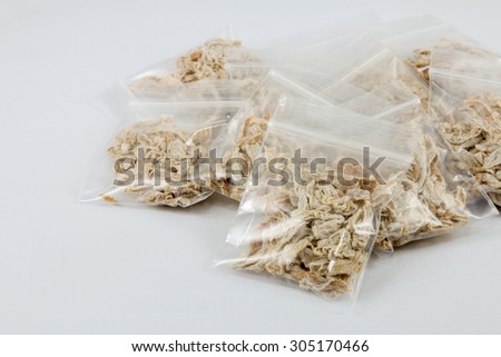 dry chinese plum in plastic pack on white background