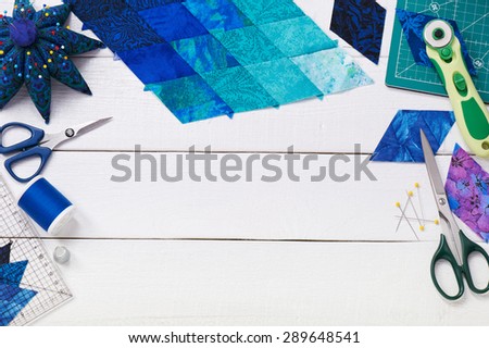 Accessories for patchwork top view on a white wooden surface