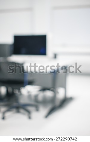 Blurry soft focus background of classroom with nobody with table, office chair, blackboard, concept of education, autumn, studying, copy space for text