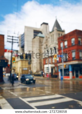 Blurred blurry soft focus background, busy downtown street with cars and lights, urban city life concept, old historical and modern buildings