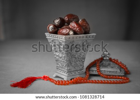 Ramadan festival background. Date fruits in an ornamental bowl with prayer beads.