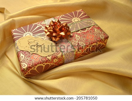 A tag with Eid message in english on a golden decorative gift box