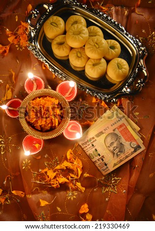 worshiping Indian currency notes as a god of wealth during Diwali Festival