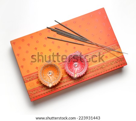 A box of sweet with sparklers sticks and traditional oil lamp
