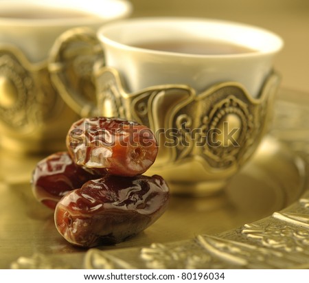 An extreme close up of dates with arabic tea cup An extreme close up of dates with arabic tea cup
