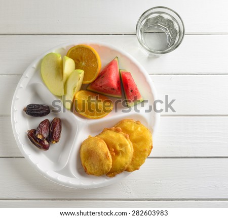 Date, fresh fruits and fried snacks. A food commonly consumed while breaking fast during holy month of Ramadan.