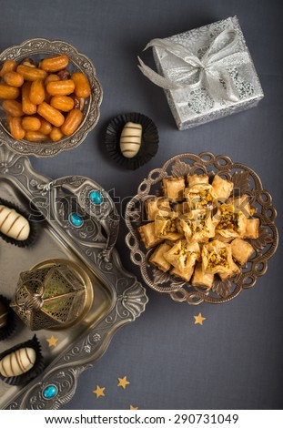 Islamic festive still life. Eid is celebrated with special sweets and distributing gifts. Studio shot from the top.