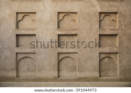 Many small arches on the grunge wall. Interior details of old arabic house.