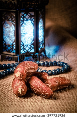 Ramadan lantern, dates and rosary still life. Traditional Egyptian Ramadan lamp with dates.