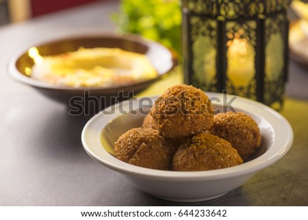 Close up of Falafel and hummus, an authentic arabic cuisine, arranged along with Ramadan traditional lantern.
