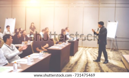 Young male business coach explaining to group of trainees concept of successful marketing campaign standing near board, smart student making report about coursework planning