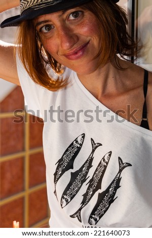 Beautiful lisbon girl dressing a white shirt with fishes,smiling