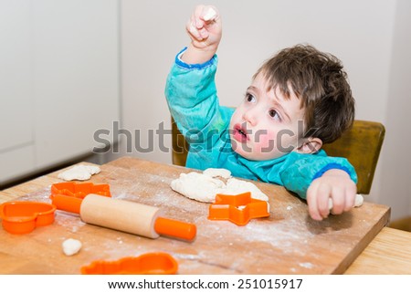 Cute caucasian baby making bread