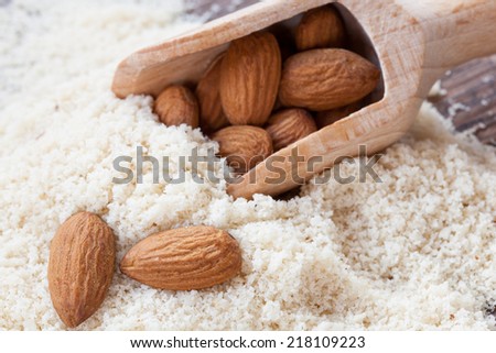 almond flour, almonds in a dark wood background
