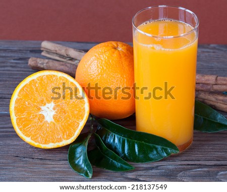 Orange juice or orange juice on background of dark wooden