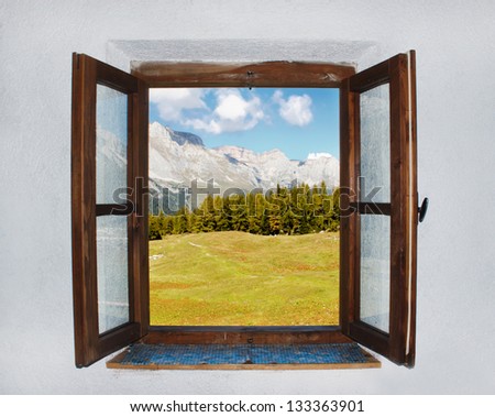 A Window With A Dark Wood Frame. The Window Is Open. Ridge Of Mountains, Forest And Meadow Visible Through The Open Window