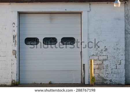 Faded brick walls and old garage door
