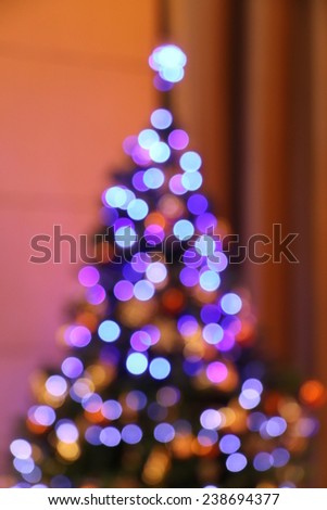 Bokeh in shape of close up Christmas tree in red light