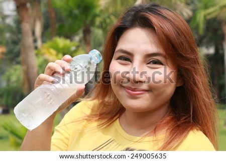 woman in garden  with drinking water in hand