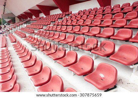 row of red seat in football stadium