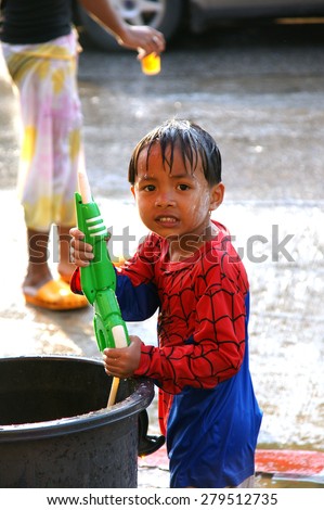 CHIANGMAI,THAILAND-APRIL 14, 2011: The boy with water pressure gun in a water fight festival or Songkran Festival (Thai New Year), on April 14, 2011 in Chiangmai, Thailand.