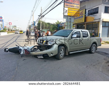 CHIANGMAI, THAILAND - JANUARY 10, 2013: Crash Accident NISSAN FRONTIER NAVARA Pickup Truck with HONDA Motorcycle at roadside in Chiangmai, Northern Thailand.