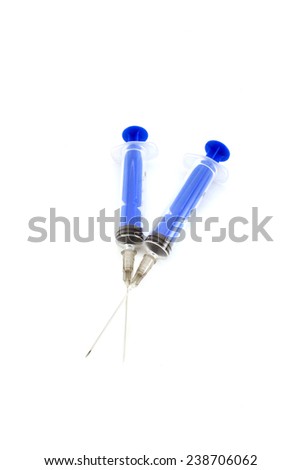 Three pink tablets with a syringe. Isolated object on white background.