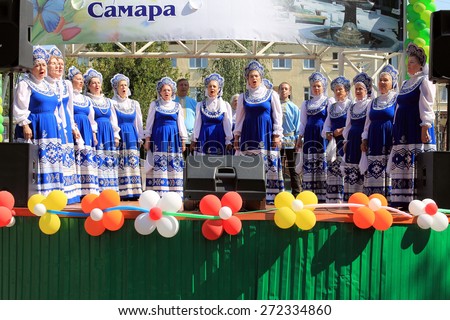 Samara, Russia - August 24, 2014: Russian folk good Unknown people sing a song on stage in Samara, Russia - August 24, 2014. The audience applauded.