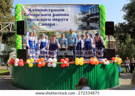 Samara, Russia - August 24, 2014: Russian folk good Unknown people sing a song on stage in Samara, Russia - August 24, 2014. The audience applauded.