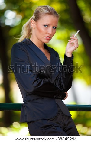 Young business woman smoking cigarette