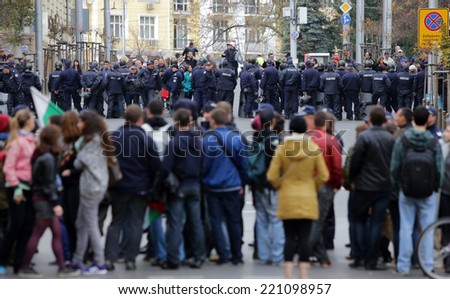 Sofia, Bulgaria - November 12, 2013: Policemen are shielding the road from people who are protesting against the Bulgarian government in the center of country\'s capital Sofia