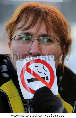 Sofia, Bulgaria - December 13, 2012: An anti-smoking activist is protesting with anti-smoking sign against idea for new amendments to the health law in Bulgaria which plan to permit smoking in public.