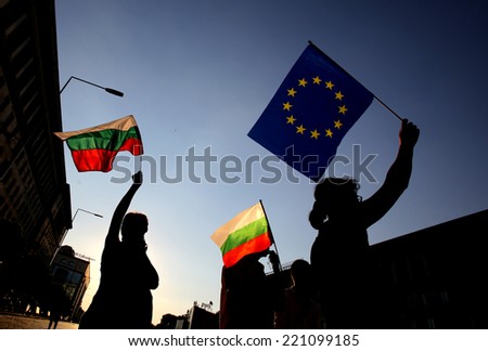 Sofia, Bulgaria - August 6, 2013: Siluettes of people holding Bulgarian and EU flags at an anti-government protest at Bulgaria\'s capital Sofia.