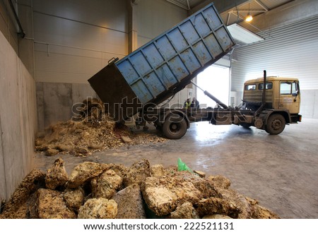 Sofia, Bulgaria - January 28, 2014: Workers are storing out of date sweets waste ready to be recycled next to an organic waste plant near Sofia.