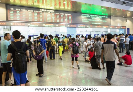 Beijing, China - August 6, 2014: People are waiting for a train at an overcrowded railway station in Beijing.