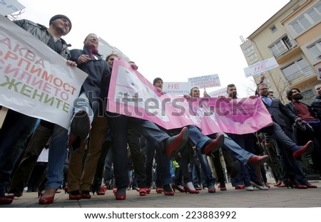 Sofia, Bulgaria - March 8, 2014: Men are walking with ladies shoes on high heels to support women victims of domestic and sexual violence as part of the international Walk a Mile in Her Shoes campaign