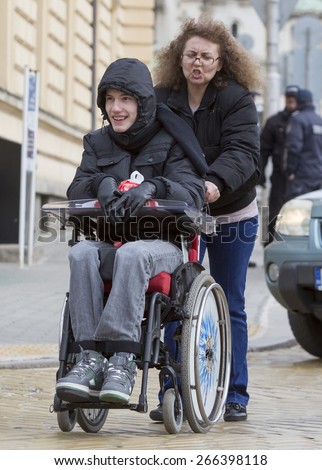 Sofia, Bulgaria - April 3, 2015: A mother and her son are going to a protest with other parents and relatives of physically disabled children and adults against discriminatory state laws.