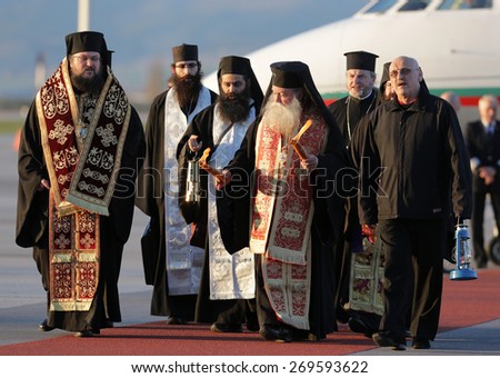 Sofia, Bulgaria - April 11, 2015: Christian priests are delivering the holy fire at Sofia airport. The sacred fire is taken from Jerusalem for Easter.